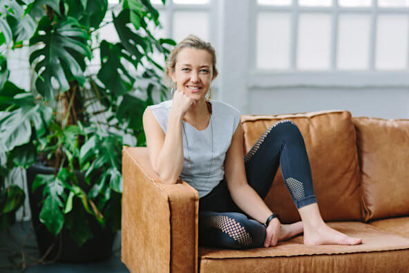 Yoga-Therapeutin Karla Stanek auf dem Sofa Ihres Yoga Studios